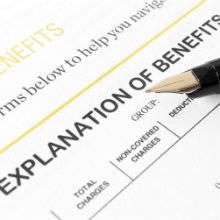 explanation of benefits form with a pen